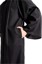 Bachelor’s Regalia Set – includes black bachelor’s gown with pockets and mortarboard cap with year-dated tassel with program color for official commencement.