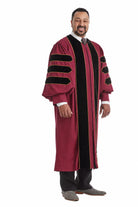 Maroon doctoral gown with black velvet panels and gold piping